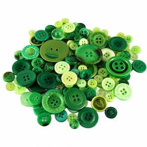 May include: A large collection of assorted sewing buttons in various shades of green, ranging from lime to dark forest green. The buttons feature different sizes, textures, and hole counts, with some displaying embossed text like Costa Marina.