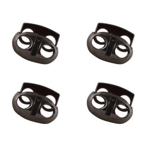 May include: Four black metal cord lock toggles with a matte finish. Each toggle has two holes and a slider mechanism.