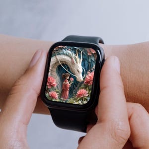 May include: Black smartwatch showing a digital illustration of a white dragon, a girl in a red dress, and pink flowers. The watch has a black strap and a rectangular face. The image has a fantasy theme.