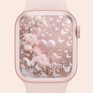Peut inclure: Une montre connectée rose doré avec un bracelet rose. L'écran affiche un motif floral avec des roses roses, des ballons en forme de cœur et des papillons blancs. L'heure est 16h45, et le jour est mardi.
