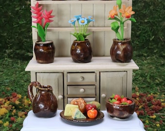 Miniature hand-thrown, hand-glazed, kiln-fired vases, flower pots, cups, pitcher, fruit bowl, and platter. Earth color scheme.