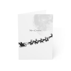 Tarjeta de felicitación navideña moderna con renos y trineo de Papá Noel, descarga digital
