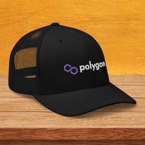 May include: Black trucker hat with a mesh back and a curved brim. The hat features the word "polygon" in white, with a purple logo. The hat is made of a durable material and is suitable for everyday wear.