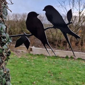 Metal Swallows sitting on a branch garden art ornament