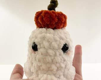 Baby ghost with a pumpkin on its head