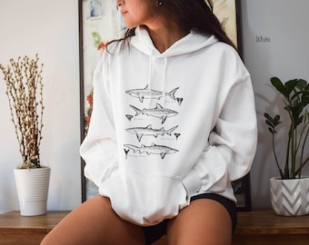May include: White hoodie with a graphic of four different shark silhouettes and their names: White Shark, Bull Shark, Lemon Shark, and Dusky Smooth-hound.