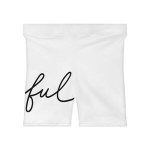 May include: White athletic shorts with a black cursive "ful" printed on the side.