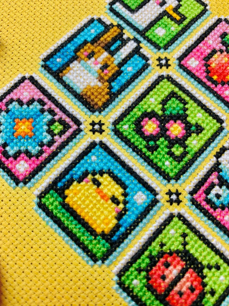 May include: A colorful cross-stitch pattern with a yellow background. The pattern features a variety of animals and objects, including a chick, a butterfly, a ladybug, and a flower. The pattern is framed in a black and white border.