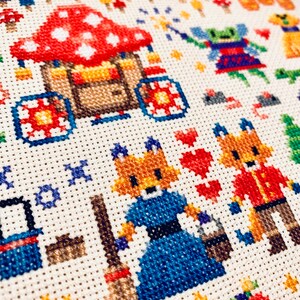 May include: Cross-stitch embroidery featuring a whimsical scene with a red and white mushroom house, two foxes, one holding a broom, and a green fairy with a wand. The background includes a variety of colorful mushrooms and stars.
