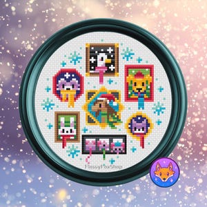 May include: A cross-stitch artwork in a teal frame, featuring a circular design with various framed animal portraits and snowflakes. The portraits include a penguin, bear, bunny, and other creatures. The artwork has a winter theme.