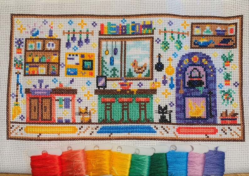 May include: Cross-stitch pattern of a kitchen with a fireplace, shelves, a window, and a cat. The kitchen is decorated with a variety of items, including a broom, a cauldron, and a chicken. The colors used in the pattern are mostly brown, yellow, green, and purple.