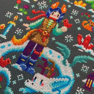 May include: A cross-stitch pattern featuring a colorful character with a red scarf and a white unicorn on a gray background. The character is wearing a brown vest and blue pants. The unicorn is surrounded by blue and white waves.
