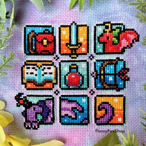 以下が含まれることがあります： 正方形のフレームに9つのピクセル化されたアイコンが配置されたクロスステッチのサンプル。アイコンには、赤いバッグ、剣、赤いユニコーン、本、ポーションボトル、弓矢、紫のユニコーン、手、渦巻く波が含まれています。