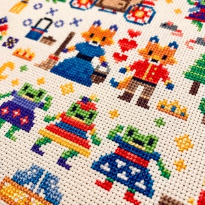 May include: Cross-stitch pattern featuring a whimsical scene with foxes, mushrooms, and other woodland creatures. The pattern is worked in a variety of colors, including red, blue, green, and yellow.
