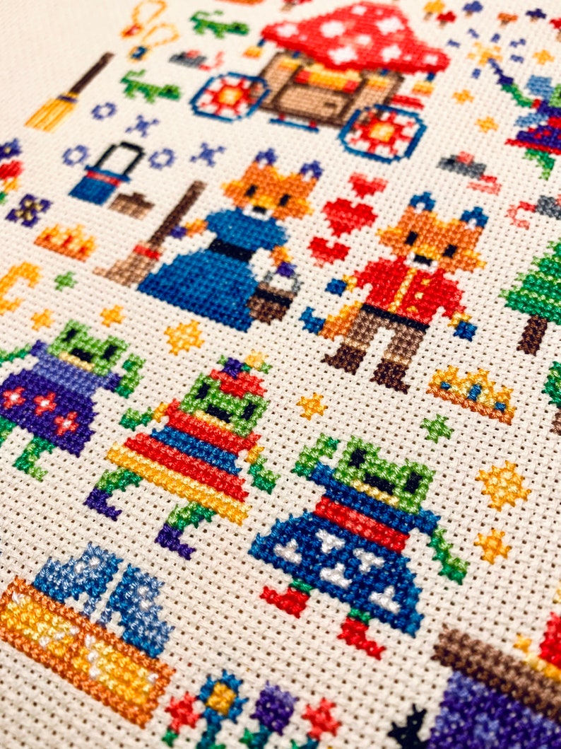 May include: Cross-stitch pattern featuring a whimsical scene with foxes, mushrooms, and other woodland creatures. The pattern is worked in a variety of colors, including red, blue, green, and yellow.
