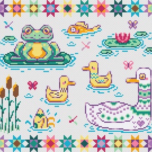 May include: A cross-stitch pattern featuring a green frog sitting on a lily pad, a white duck with purple and green stripes, a yellow duck, a pink flower, and a yellow fish. The pattern is surrounded by a colorful border of stars.