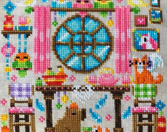 May include: A colorful cross-stitch design featuring a whimsical scene with birds, a fox, and a capybara. The design includes a round window, pink curtains, and a table set with teacups. The overall theme is a cozy, storybook aesthetic.