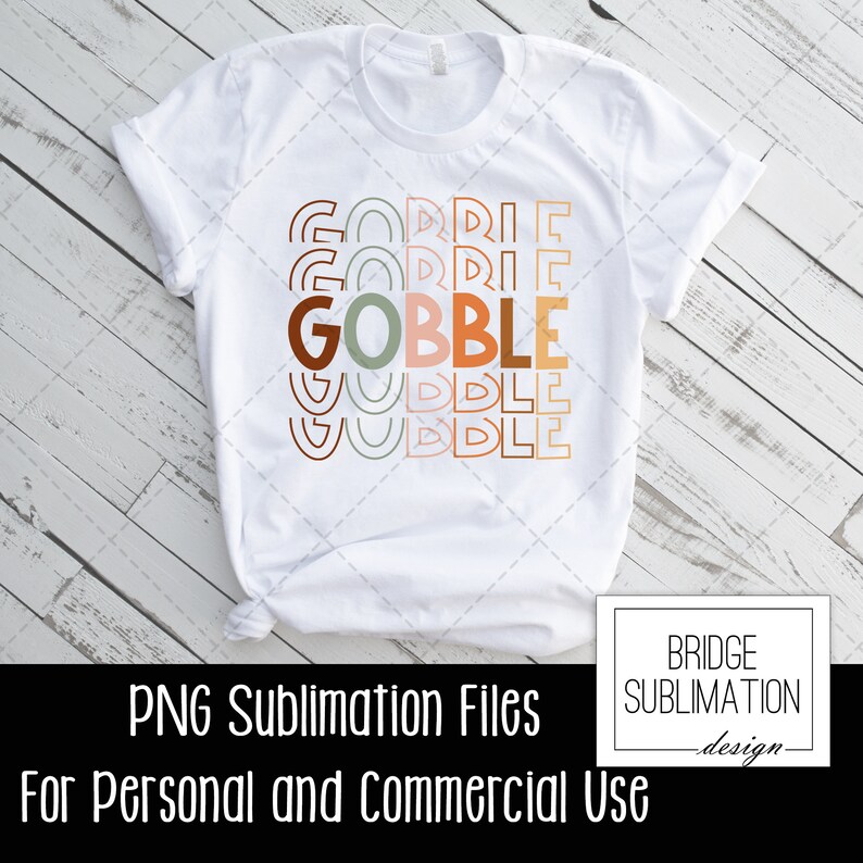 May include: White t-shirt with the word "GOBBLE" in large, colorful letters. The word is stacked with the words "GORRIE" and "WUDDLE" above and below. The shirt also has the text "PNG Sublimation Files For Personal and Commercial Use".