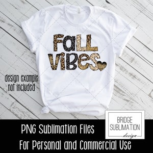 May include: White t-shirt with the text "Fall Vibes" in black letters with a leopard print design. The text is layered with a gold glitter effect. A small heart with a leopard print design is to the right of the text.