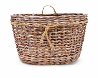 May include: A rectangular wicker basket with a rounded base. The basket is light brown with white highlights and a rope detail tied around the top. It has a small handle. The basket is made of woven material.