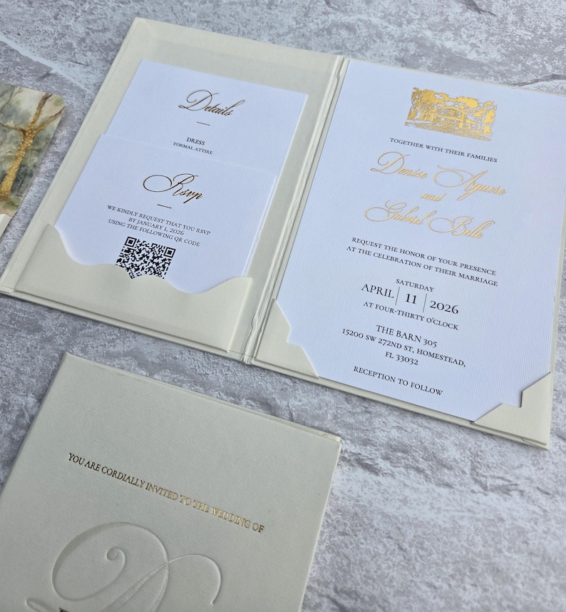 K&ouml;nnte beinhalten: Elfenbein-Hochzeitseinladungs-Suite mit Goldfolientext. Die Einladung enth&auml;lt Details, RSVP und Veranstaltungsinformationen. Die Suite wird in einem Ordner im Taschenstil mit einer passenden Karte pr&auml;sentiert.