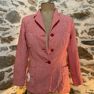 May include: A red and white gingham blazer with a single button fastening and a patch pocket on the left side.