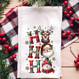 May include: A white kitchen towel with a red, green, and white plaid design. The towel features a festive Christmas design with the words "HO HO HO" and illustrations of Santa Claus, a snowman, and a reindeer.