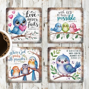 May include: Set of four square coasters featuring watercolor illustrations of bluebirds with inspirational quotes about love and faith. The quotes include "Love never fails", "With God all things are possible", "Where God guides He provides", and "If God is for us who can be against us?"