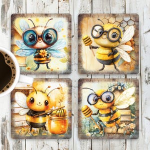 May include: Set of four square coasters featuring cartoon bees with glasses. Each coaster has a different bee design with a yellow and black striped body, brown legs, and a pair of round glasses. The bees are on a brown wooden background with yellow and white flowers.