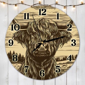 May include: A round clock face features a brown and black Highland cow with long, shaggy hair. The clock face has a cream background with black Roman numeral hour markers. The cow's face is centered on the clock face, and its horns are pointing to the left and right.