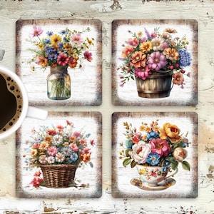 May include: Set of four square coasters featuring floral arrangements. Each coaster showcases a different bouquet: a mason jar, a wooden bucket, a woven basket, and a teacup, all filled with colorful flowers. The coasters have a rustic, weathered wood-look border.