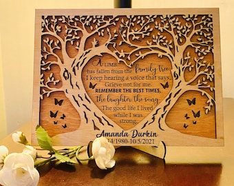 May include: A rectangular wooden memorial plaque featuring a laser-cut tree design forming a heart shape in the center. The text reads: A LIMB has fallen from the family tree I keep hearing a voice that says, Grieve not for me. REMEMBER THE BEST TIMES, the laughter the song The good life I lived while I was strong. Amanda Durkin 1980-2021.