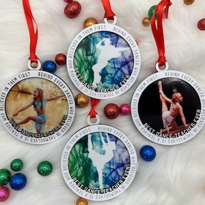 May include: Three round, white, wooden ornaments with silver trim. Each ornament features a different image of a dancer and the text "Behind every dancer who believed in themselves is a teacher who believed in them first. Best dance teacher ever."