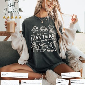 May include: A pepper-colored sweatshirt with a white graphic design featuring an anchor, trees, a boat, and the text "with love from LAKE TAHOE jones family lake trip." The image also includes the text "Exactly what I wanted!"