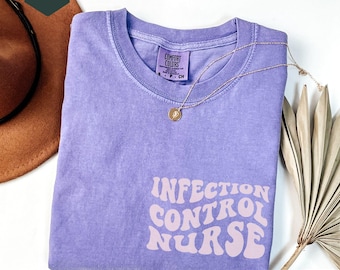 May include: A purple t-shirt with the text "INFECTION CONTROL NURSE" in a retro font. The shirt is made by Comfort Colors.