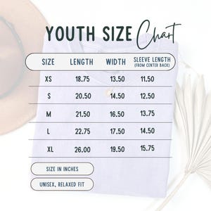 May include: White t-shirt with a youth size chart printed on it. The chart lists sizes XS to XL, with measurements in inches for length, width, and sleeve length. The shirt is described as unisex and relaxed fit.