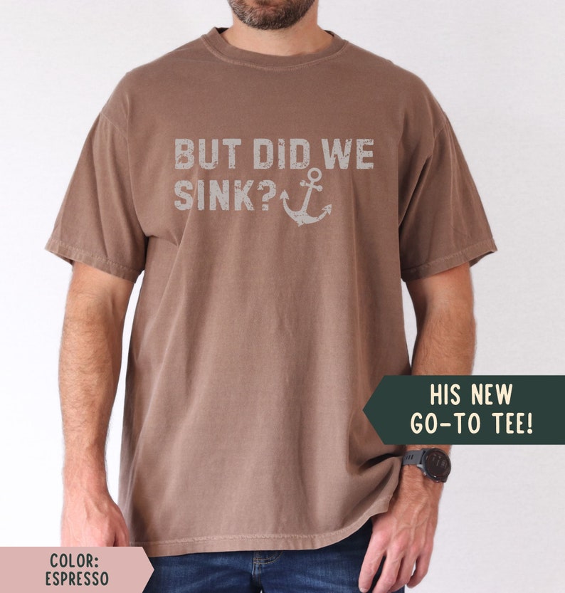May include: A brown t-shirt with the text "BUT DID WE SINK?" and an anchor graphic. The text is in a distressed font.