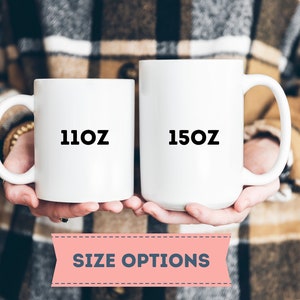 May include: Two white ceramic mugs with black text. The mug on the left says "11oz" and the mug on the right says "15oz".