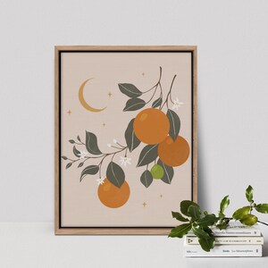 May include: A framed print of a stylized illustration of an orange tree with green leaves, white blossoms, and orange fruit. The background is a light peach color with a crescent moon and stars.