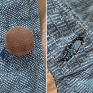 May include: Close-up of a blue and white patterned fabric with a brown button and a black buttonhole.