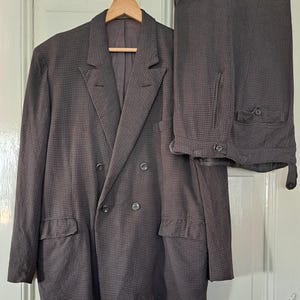 May include: A double-breasted suit jacket and matching pants in a brown and black checkered pattern.