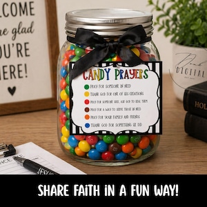 May include: A glass jar filled with colorful candies, topped with a black bow, and a tag that reads "Candy Prayers." The jar sits on a wooden surface with a pen, attendance sheet, and a sign that says "Welcome, We're glad you're here!" The text "Share faith in a fun way!" is also visible.