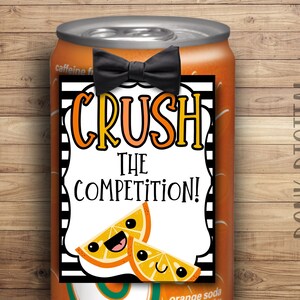 May include: Orange soda can with a black and white striped tag that says "Crush the Competition!" with a black bow tie and two orange slices with smiley faces.