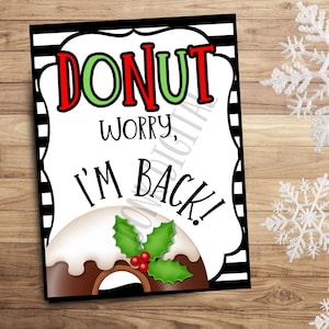 May include: A white sign with black and white stripes on the border. The sign says "Donut worry, I'm back!" in black text with a red and green donut illustration.