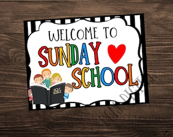 May include: Welcome to Sunday School sign with a red heart and a group of children holding a Holy Bible. The sign has black and white stripes with a white background.