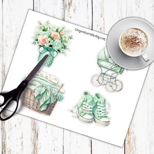 May include: A sheet of stickers featuring watercolor illustrations of baby-themed items. Includes a baby carriage, a basket of blankets, a bouquet of flowers, and a pair of sneakers. The text "GingerJournals.etsy.com" is visible.