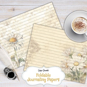 May include: Two sheets of lined paper with a vintage aesthetic featuring a daisy design. The paper is cream colored with brown lines and a faint floral pattern. The text "Ginger Journals Foldable Journaling Papers" is printed on the bottom of the image.