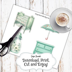 May include: A sheet of paper with baby-themed stickers, including a crib, dresser, bottle, and umbrella. The stickers are in shades of green and white, with floral accents. The text "Download, Print, Cut and Enjoy!" is also present.