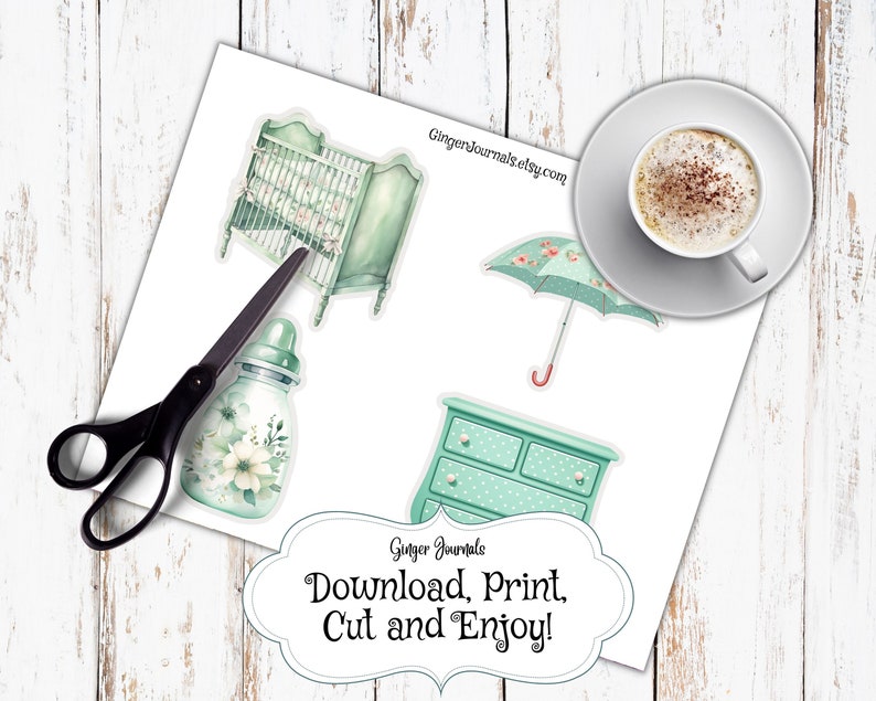 May include: A sheet of paper with baby-themed stickers, including a crib, dresser, bottle, and umbrella. The stickers are in shades of green and white, with floral accents. The text "Download, Print, Cut and Enjoy!" is also present.