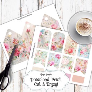 May include: Printable digital download of 10 vintage floral themed gift tags and banners. The tags feature a distressed background with pink, white, and blue flowers. The banners have a floral pattern with a light blue background. The text on the page reads "Download, Print, Cut, & Enjoy!"